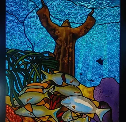 Detail of a reef fish panel in textured blue and gold glass