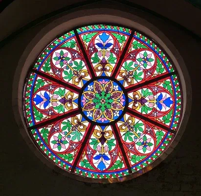 Stained glass panel of tropical fish among coral