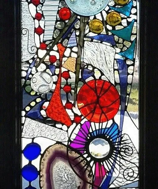 Abstract leaded panel set with a polished agate slice, glass rondels and bevels